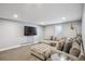 Finished basement with a large sectional sofa and TV at 4970 S Chester St, Greenwood Village, CO 80111