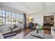 Sunlit living room showcasing hardwood floors, a sitting area, and a view into dining room at 4970 S Chester St, Greenwood Village, CO 80111