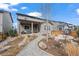 Landscaped backyard featuring gravel paths and an inviting covered patio at 6220 Waterman Way, Frederick, CO 80516