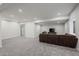 Large basement with cozy seating area, TV, and ample open space at 6220 Waterman Way, Frederick, CO 80516