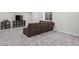 Cozy basement area with a plush sofa, TV, and shelving for entertainment at 6220 Waterman Way, Frederick, CO 80516