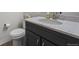Clean bathroom with gray vanity, marble countertop, and modern fixtures at 6220 Waterman Way, Frederick, CO 80516