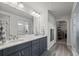 Modern bathroom with double vanity, stylish mirrors, and a luxurious marble shower at 6220 Waterman Way, Frederick, CO 80516