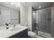 Modern bathroom featuring a sleek vanity and a glass-enclosed shower at 6220 Waterman Way, Frederick, CO 80516