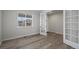 Bright, empty bedroom showcasing modern floors, large window, and white trim at 6220 Waterman Way, Frederick, CO 80516
