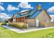 Beautiful clubhouse with a wood facade, metal roof and lush landscaping at 6220 Waterman Way, Frederick, CO 80516