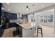 Stunning kitchen features an island with seating, stainless steel appliances, and elegant pendant lighting at 6220 Waterman Way, Frederick, CO 80516