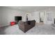 Comfortable living space with a brown sectional sofa and a modern entertainment center at 6220 Waterman Way, Frederick, CO 80516