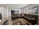 Open-concept living room with plush sectional sofa and view of the contemporary kitchen at 6220 Waterman Way, Frederick, CO 80516
