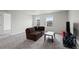 Cozy living room with plush brown sofa, sleek coffee table, and neutral walls at 6220 Waterman Way, Frederick, CO 80516