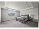 Spacious bedroom with tray ceilings, large window, and modern furnishings at 6220 Waterman Way, Frederick, CO 80516