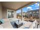 Relaxing covered patio with an outdoor seating area and landscaped surroundings at 6220 Waterman Way, Frederick, CO 80516