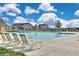 Community pool with lounge chairs, perfect for relaxing and enjoying the sun at 6220 Waterman Way, Frederick, CO 80516