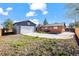 Backyard featuring a detached garage, patio, and yard ready for gardening at 421 Iola St, Aurora, CO 80010