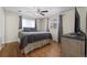 Well-lit bedroom with hardwood floors and large windows featuring blackout curtains at 421 Iola St, Aurora, CO 80010