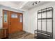 Welcoming foyer with beautiful front door, coat rack and bench, creating a great first impression at 421 Iola St, Aurora, CO 80010