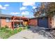 Charming brick home with covered patio, lush landscaping, and attached garage, perfect curb appeal at 421 Iola St, Aurora, CO 80010