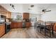 Spacious kitchen with modern appliances, wood cabinets, and a dining area for convenient meals at 421 Iola St, Aurora, CO 80010