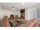 The living room features a leather sectional couch and brick fireplace at 421 Iola St, Aurora, CO 80010