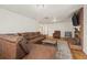 Spacious living room featuring a brick fireplace, leather furniture and hardwood flooring at 421 Iola St, Aurora, CO 80010