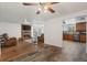 Open living room with fireplace, hardwood floors, and kitchen view, offering a spacious design at 421 Iola St, Aurora, CO 80010