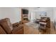 Comfortable living room features a brick fireplace, wood floors, and lots of natural light at 421 Iola St, Aurora, CO 80010