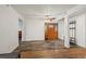 Bright, open-concept living area with hardwood floors, decorative front door, and stylish coat rack at 421 Iola St, Aurora, CO 80010
