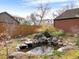 Backyard featuring a serene pond with natural stone accents and landscaping at 1944 Hudson St, Denver, CO 80220
