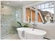 Bright bathroom with large window, soaking tub, and marble-tiled walk-in shower at 1944 Hudson St, Denver, CO 80220