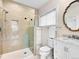 Well-lit bathroom showcasing a glass shower, marble countertop, and updated fixtures at 1944 Hudson St, Denver, CO 80220