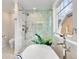 Bright bathroom featuring a glass shower, marble tile, and luxurious fixtures at 1944 Hudson St, Denver, CO 80220