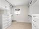 Spacious walk-in closet featuring custom cabinets and ample storage space at 1944 Hudson St, Denver, CO 80220