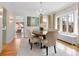 Elegant dining room with hardwood floors, chandelier lighting, and views through large windows at 1944 Hudson St, Denver, CO 80220