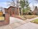 Stunning brick home featuring a landscaped yard and driveway at 1944 Hudson St, Denver, CO 80220