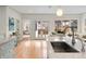 Bright and modern kitchen with stainless steel appliances, marble countertops and light-green cabinetry at 1944 Hudson St, Denver, CO 80220