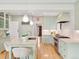 Charming light green kitchen with marble countertops, stainless steel appliances, and a spacious central island at 1944 Hudson St, Denver, CO 80220