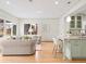 Spacious open concept living area with bright and modern kitchen with island seating at 1944 Hudson St, Denver, CO 80220