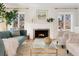 Bright living room features a cozy fireplace, large windows, comfortable seating, and stylish decor at 1944 Hudson St, Denver, CO 80220