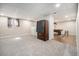 Open finished basement with carpet and tile floors, pool table, and neutral walls at 1030 S Fulton Ave, Fort Lupton, CO 80621