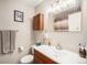 Clean bathroom featuring a single sink vanity, mirrored medicine cabinet, and neutral decor at 1030 S Fulton Ave, Fort Lupton, CO 80621