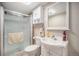 Clean bathroom with walk-in shower, vanity, mirrored medicine cabinet, and neutral walls at 1030 S Fulton Ave, Fort Lupton, CO 80621