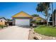 Well-maintained home with a long driveway, attached garage, and beautifully landscaped front yard at 1030 S Fulton Ave, Fort Lupton, CO 80621