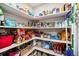 Organized walk-in pantry with shelves stocked with food and household items at 1030 S Fulton Ave, Fort Lupton, CO 80621