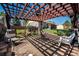 Inviting outdoor space with a pergola, fan, brick patio, and plenty of seating at 1030 S Fulton Ave, Fort Lupton, CO 80621
