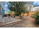 A view of the backyard featuring a wood deck, privacy fence, a grill, and mature trees and landscaping at 2782 S Ceylon St, Aurora, CO 80013