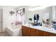 Bright bathroom featuring dual sinks and a separate tub at 2782 S Ceylon St, Aurora, CO 80013