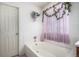 Clean bathroom features a tub with white tile and decorative floral accents at 2782 S Ceylon St, Aurora, CO 80013
