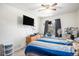 Bedroom features a mounted television and a window with black curtains at 2782 S Ceylon St, Aurora, CO 80013