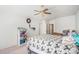 Bright bedroom features a ceiling fan and a comfortable floral patterned bed at 2782 S Ceylon St, Aurora, CO 80013