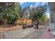 Spacious backyard deck featuring a grill, privacy fence, seating and mature landscaping and trees at 2782 S Ceylon St, Aurora, CO 80013